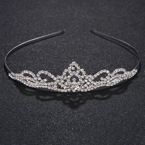 Detailed view of silver rhinestone tiara with intricate sparkling crystal patterns