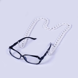 Detail of white acrylic eyewear chain linked to glasses in a minimalist retro style