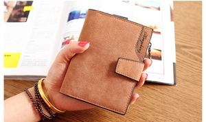 Detailed view of a brown frosted leather short wallet featuring a snap button and zipper pocket