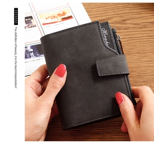 Detailed view of a dark grey bi-fold wallet with buckle closure and side zipper pocket