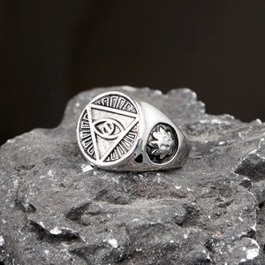 Vintage stainless steel signet ring featuring Eye of Providence on dark rock background