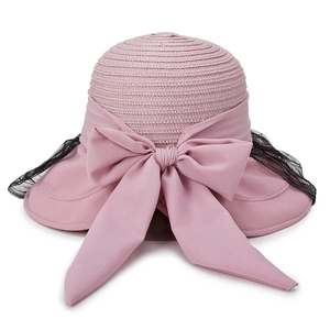 Pink straw sun hat with large bow and black lace mesh veil for beach vacations