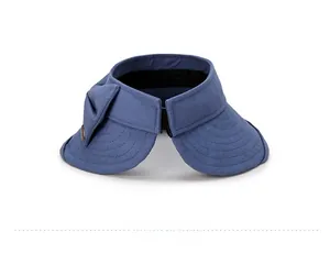 Detail view of the large bow decoration on a navy blue sun visor beach hat