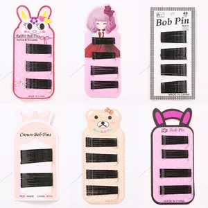 Variety set of black bobby pins displayed on six different cartoon patterned cards