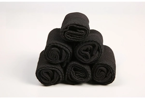 Pyramid stack of six black bamboo fiber socks for men showing soft material texture