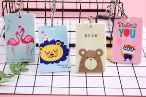 Detail of four cute animal card holders with keychain rings on grid background