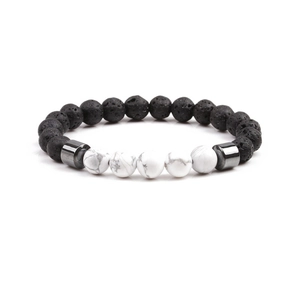 Beaded stretch bracelet featuring black lava rock, white turquoise, and metal accents