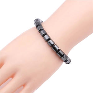 Minimalist black cylindrical bead magnetic elastic bracelet worn on the wrist