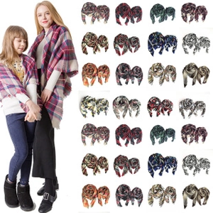 Matching mother and child wearing thick winter scarves with plaid and solid patterns