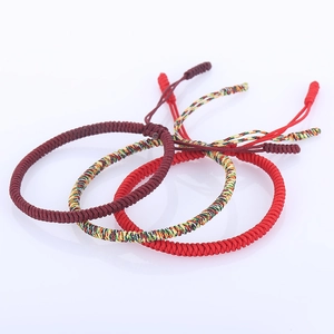 Three handmade braided red and multicolored cord bracelets with adjustable knots