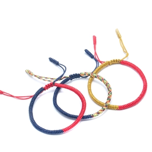 Close-up of handmade braided cord bracelets showing detailed knot textures and colors