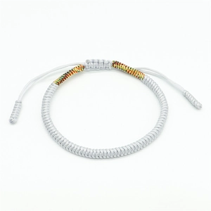 Macro shot of white handmade woven cord bracelet featuring adjustable sliding knot detail