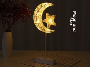 Warm LED moon and star woven desk lamp on a stand creating a cozy night ambiance