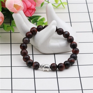 Tiger eye and purple agate beaded elephant bracelet displayed on a white hand model