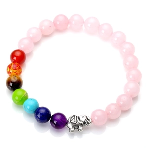 Pink gemstone beads chakra bracelet featuring silver elephant pendant on white background