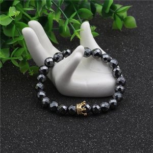 Black faceted hematite beaded bracelet featuring a golden micro-pave zircon crown charm