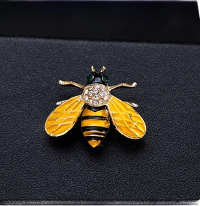 Macro shot of bee brooch with yellow and black enamel finish and sparkling crystals