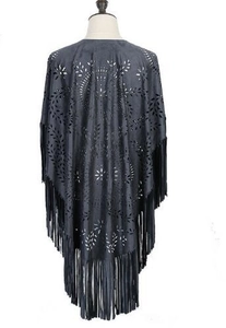 Detail view of dark grey faux suede poncho featuring hollow leaf patterns and long tassels
