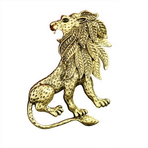 Vintage lion head brooch in antique gold finish with detailed leaf-pattern mane texture