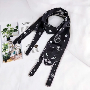Polka dot silk scarf featuring a black cat illustration on a white fabric background