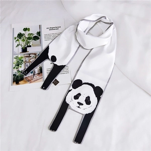 Detail of white polyester scarf featuring cute panda prints and material label