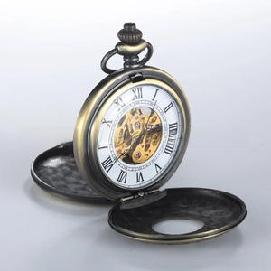 Detail view of vintage bronze mechanical pocket watch showing golden skeleton movement