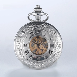 Macro detail of vintage silver mechanical pocket watch with baroque hollow floral carvings
