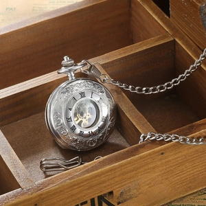 Close-up of vintage hollow mechanical pocket watch with silver floral engraving