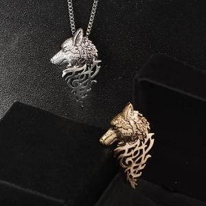 Retro wolf head totem necklaces in gold and silver metal finish on black background