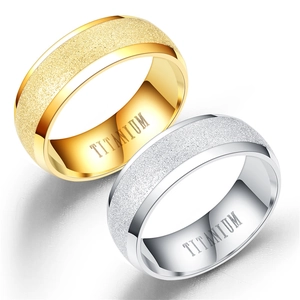 Detail view of titanium rings showing sandblasted finish and internal material engraving