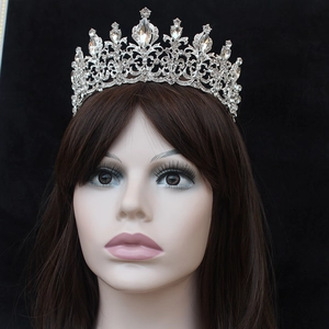 Detailed close-up of a silver Baroque bridal crown with crystals on a model