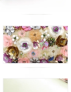 Detail of handcrafted sequin flowers with pearls on premium evening clutch fabric