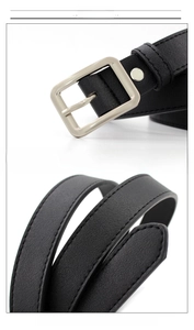 Detail view of the black PU leather belt strap and polished zinc alloy square buckle