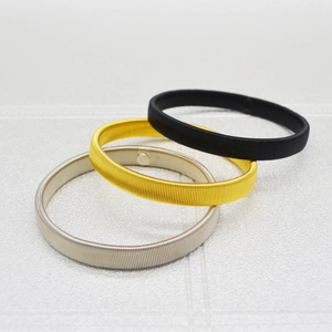 Men's metal spring armbands in black gold and silver with textured surface detail