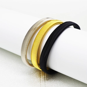 Men's metal spring armbands in silver, gold, and black with spiral textured design