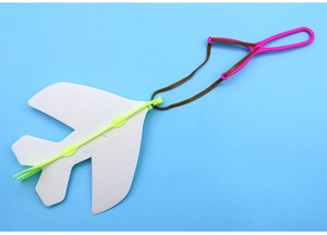 Detailed view of foam glider plane toy with pink launcher handle and green frame