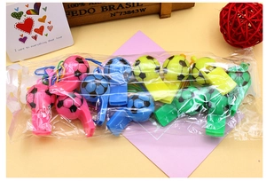 Detail of colorful plastic soccer whistles with lanyards in transparent gift packaging