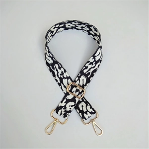 Close-up of black and white leopard print woven wide strap with gold metal hardware