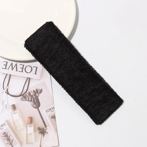 Minimalist black cotton terry sport headband for yoga and gym on white background