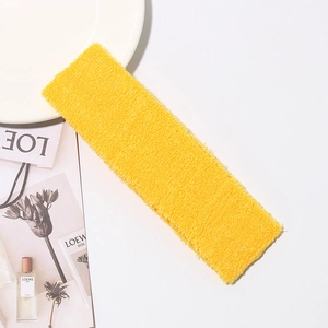 Detailed texture of yellow cotton terry headband for yoga sports on a white table
