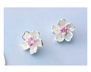 Macro detail of cherry blossom earrings in 925 silver with pink zircon center stones