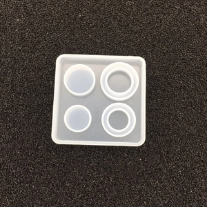 Macro detail of a 4-cavity square silicone mold for resin pendants and DIY crafts