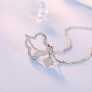Detailed macro shot of a S925 silver double clover pendant with sparkling zircon stones
