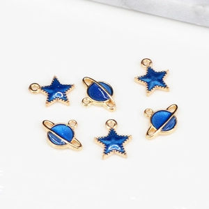 Detailed view of blue enamel star and planet charms with gold alloy frames for DIY jewelry