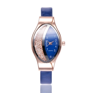 Detail of creative oval watch with rose gold case and flowing rhinestones on blue dial