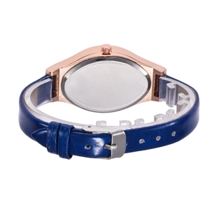 Detail view of the rose gold watch case and navy blue leather strap with buckle