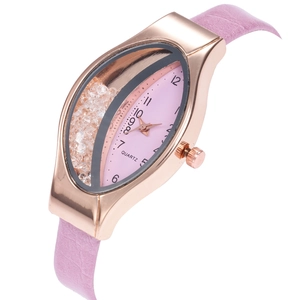 Close-up of pink leather watch with flowing crystals inside a rose gold almond-shaped case