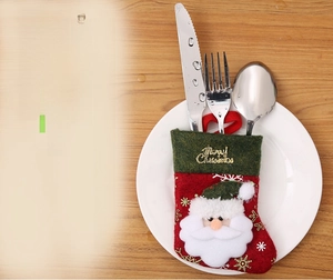 Close-up of Santa Claus cutlery holder stocking with Merry Christmas print and silverware