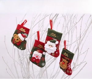 Close-up of Christmas cutlery holders featuring Santa, elk, and snowman with gold embroidery