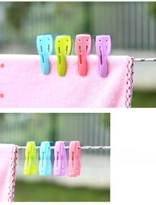 Detail view of colorful windproof plastic clothespins with strong metal springs on a clothesline